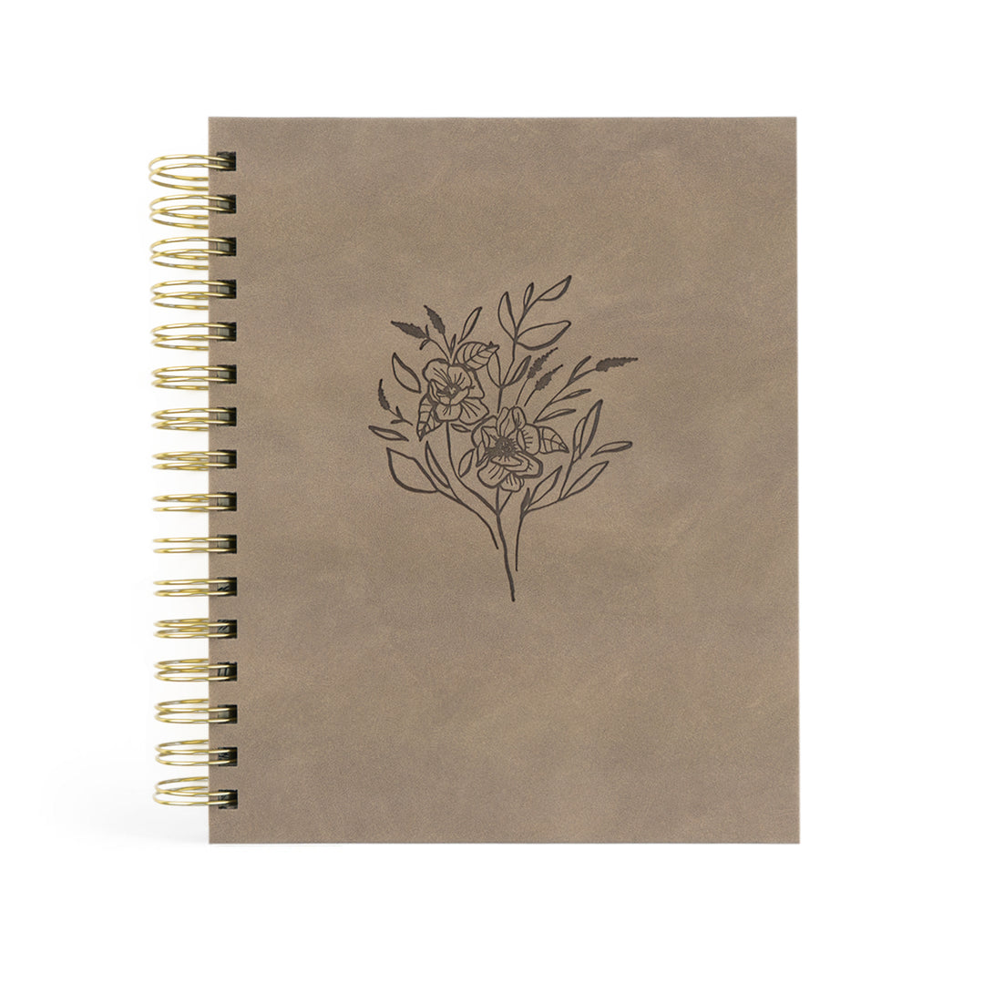 Brown planner with floral design on a white background