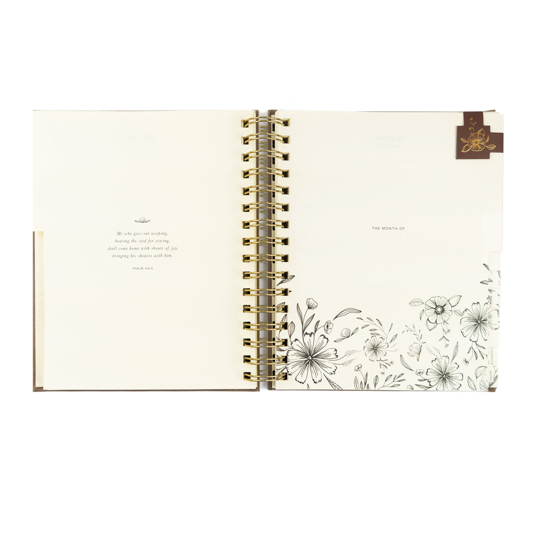 Open notebook with floral design on a white background
