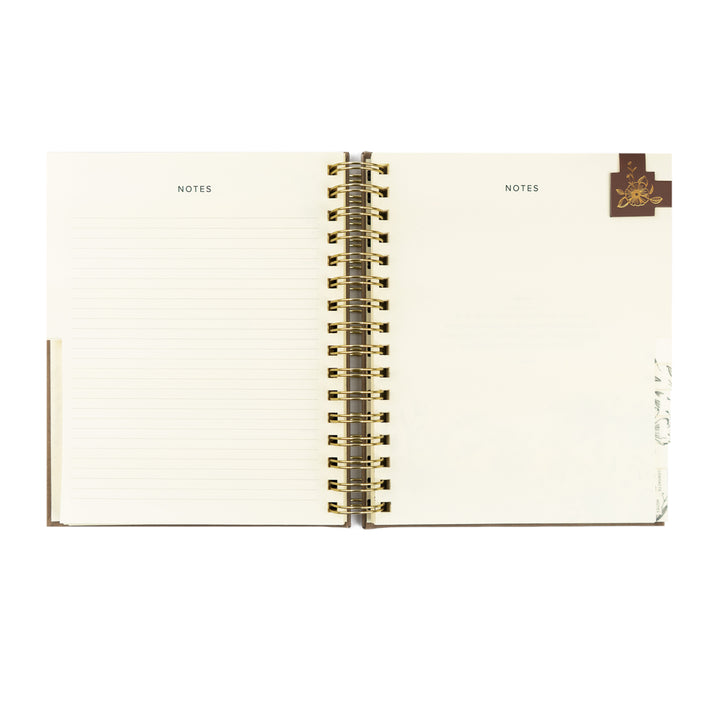Open notebook with 'NOTES' label on each page, gold spiral binding, and brand logo on a white background.