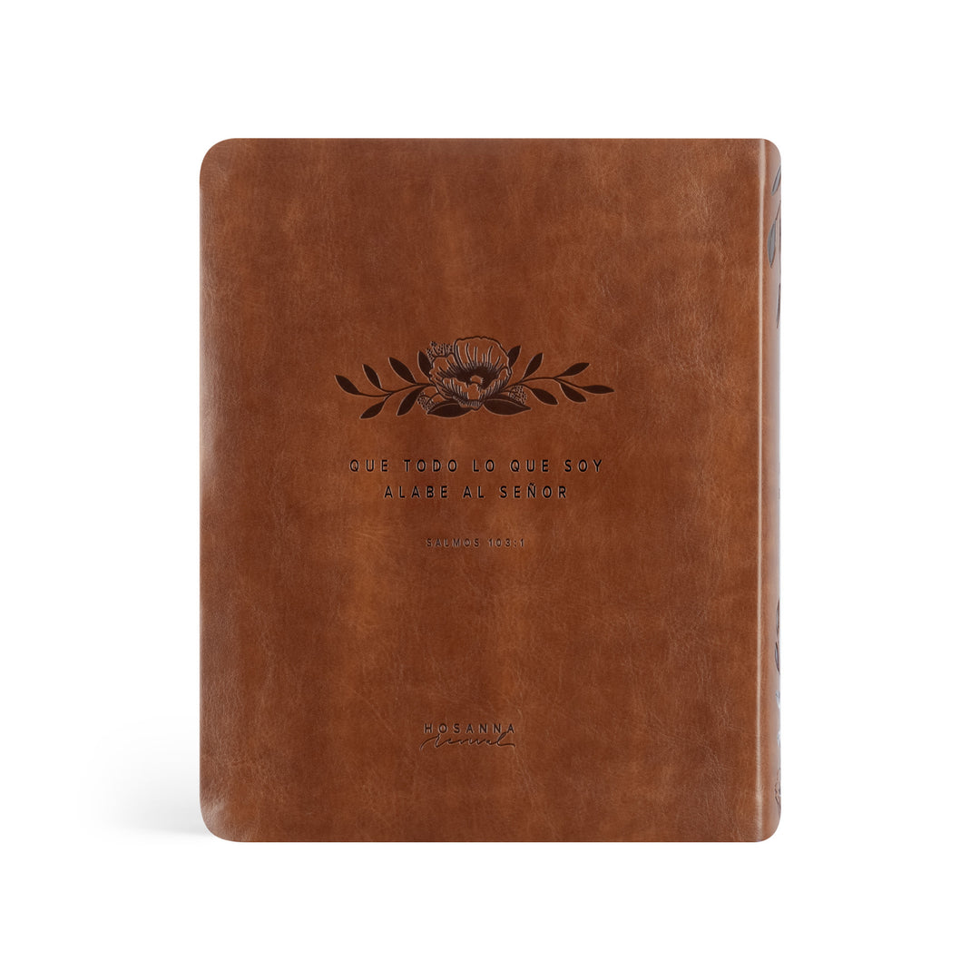 Brown leather notebook with embossed design and text on a white background