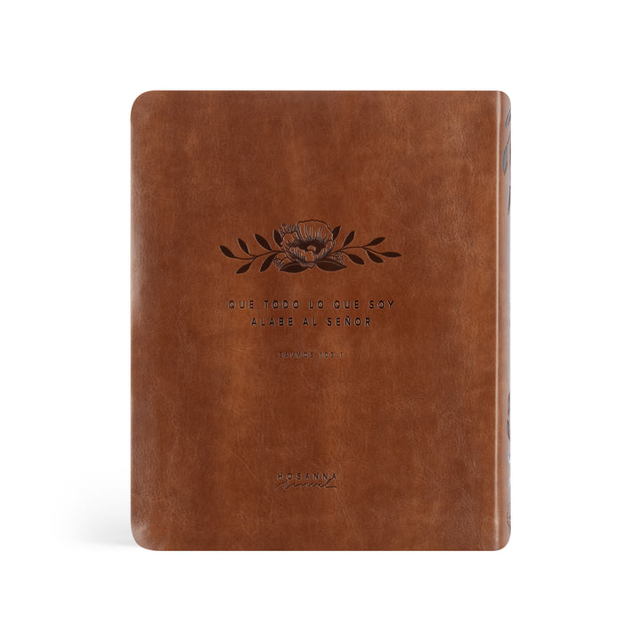 Brown leather notebook with embossed design and text on a white background