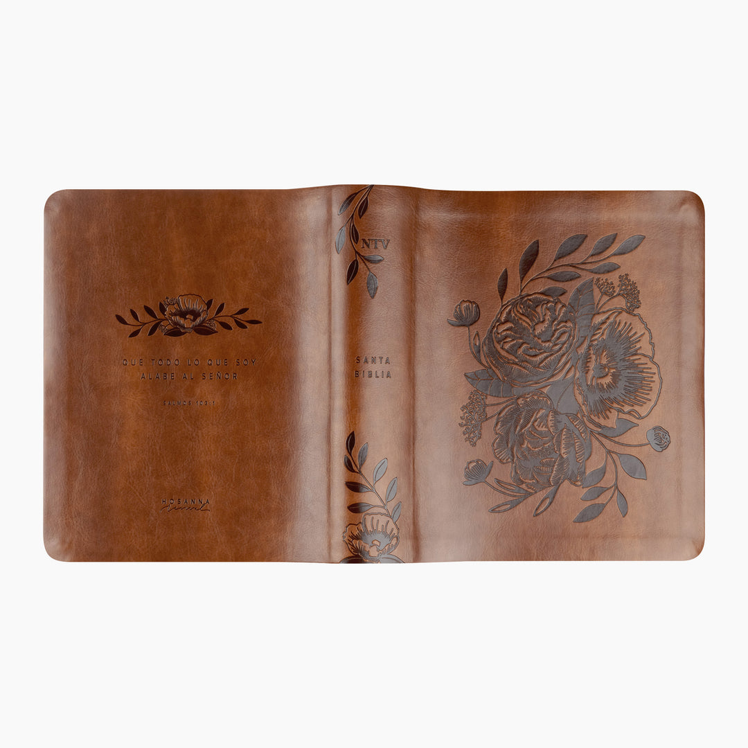 Brown leather notebook with floral embossing on a white background