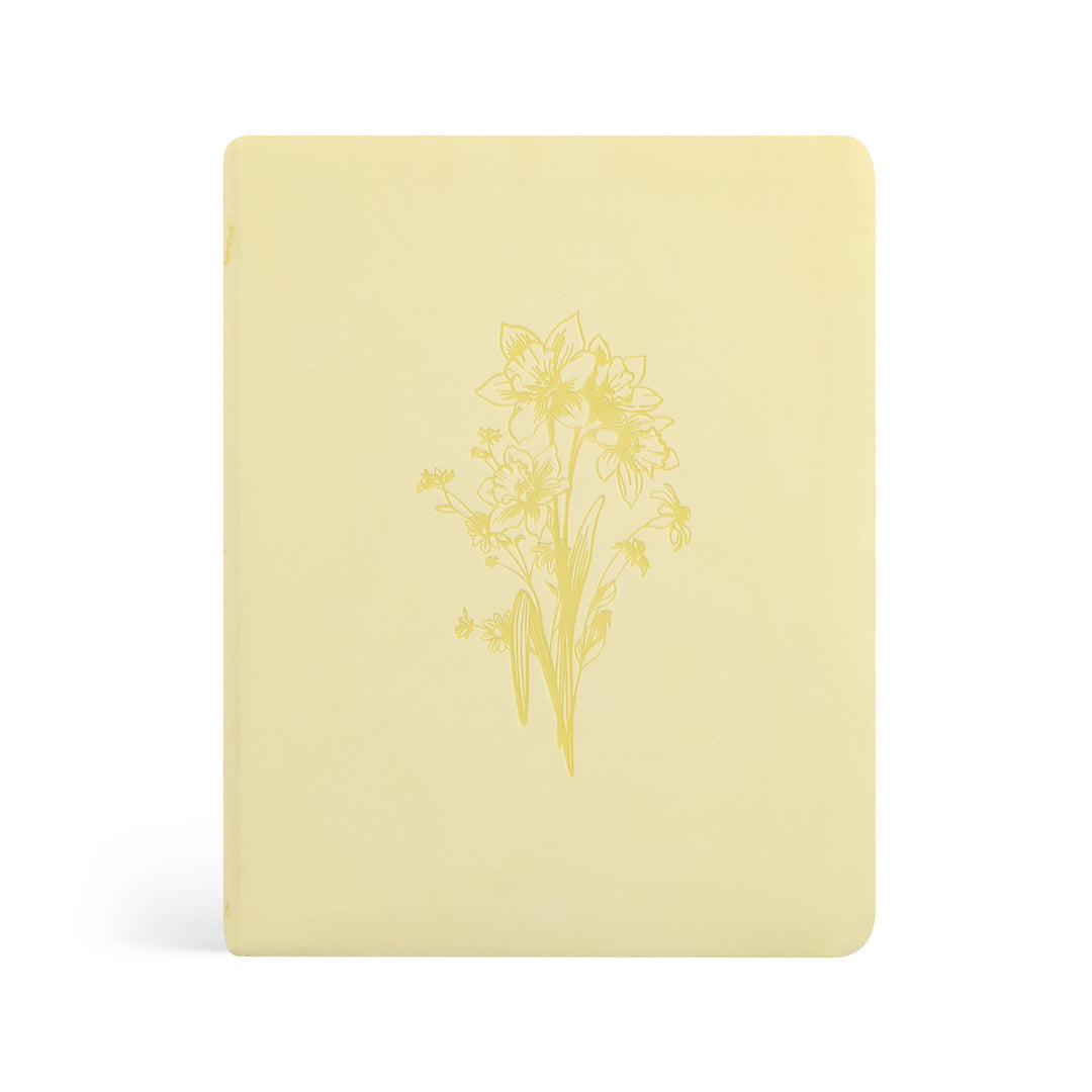 Yellow Bible with floral design on a white background