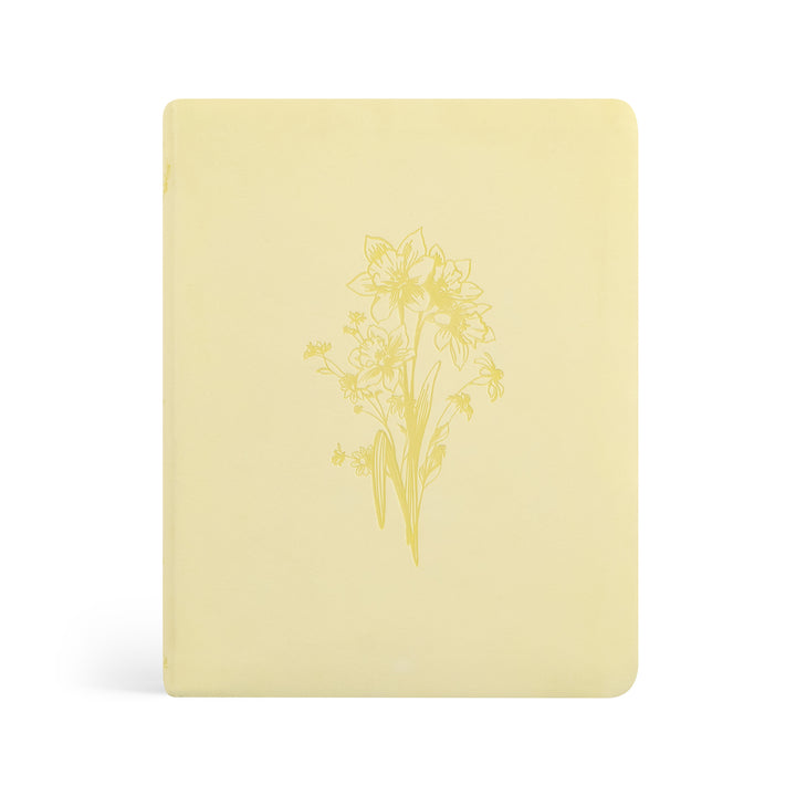 Yellow Bible with floral design on a white background