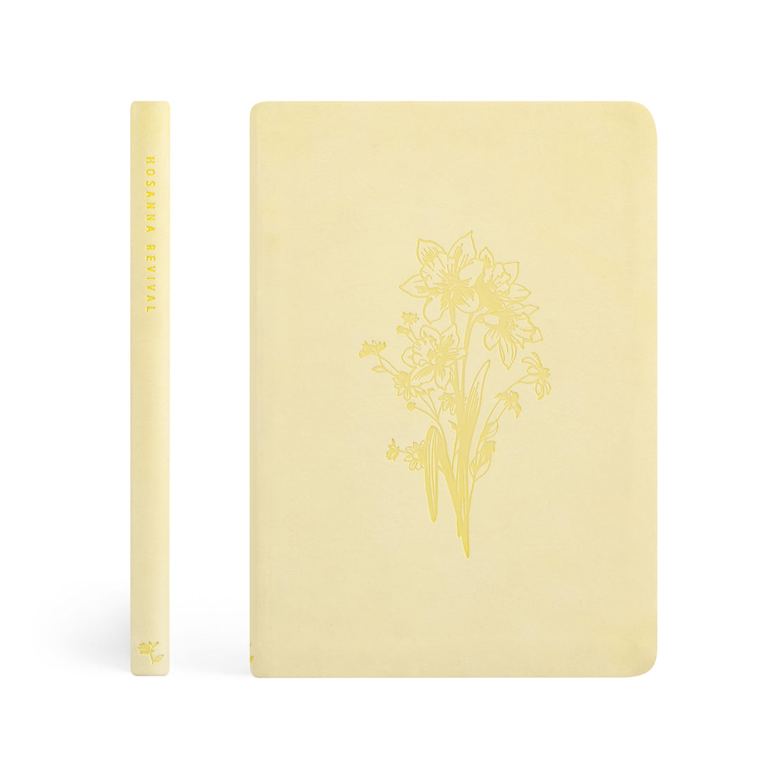 Yellow notebook with floral design on a white background