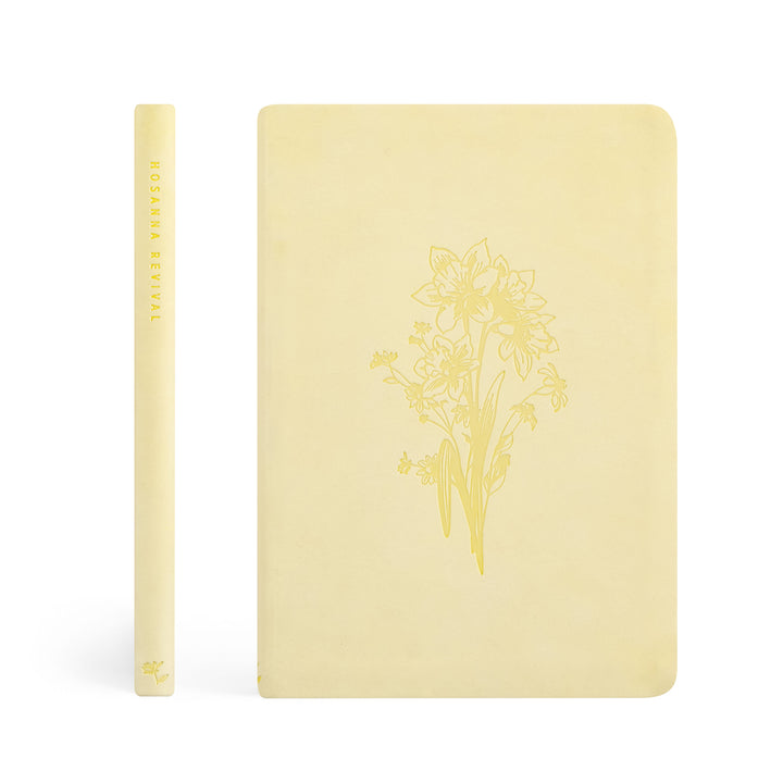 Yellow notebook with floral design on a white background