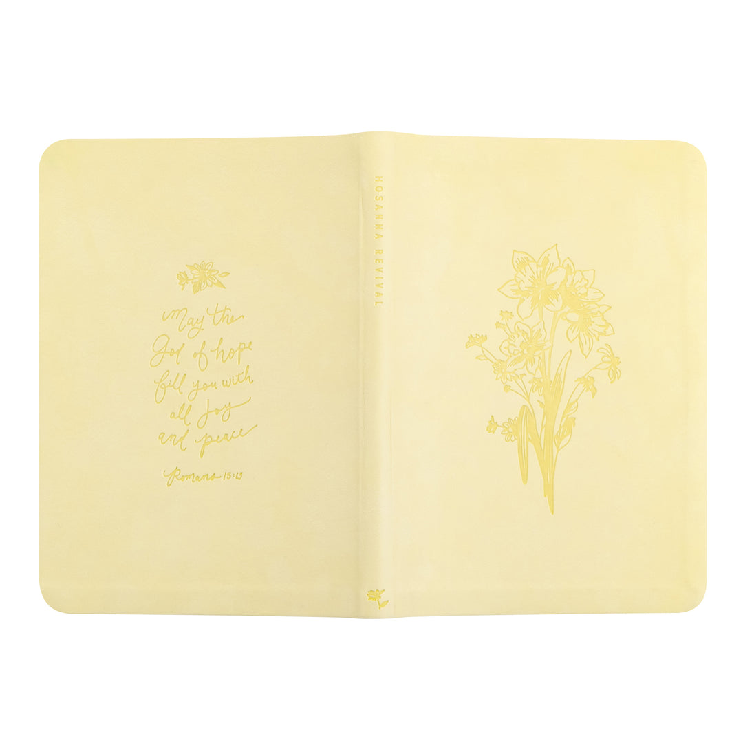 Yellow notebook with floral design and text on a white background