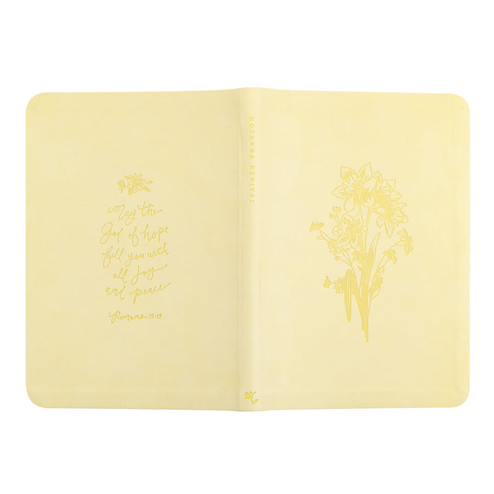 Yellow notebook with floral design and text on a white background