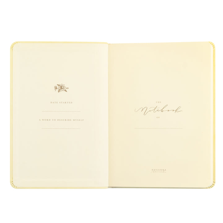 Open notebook with decorative cover on a white background