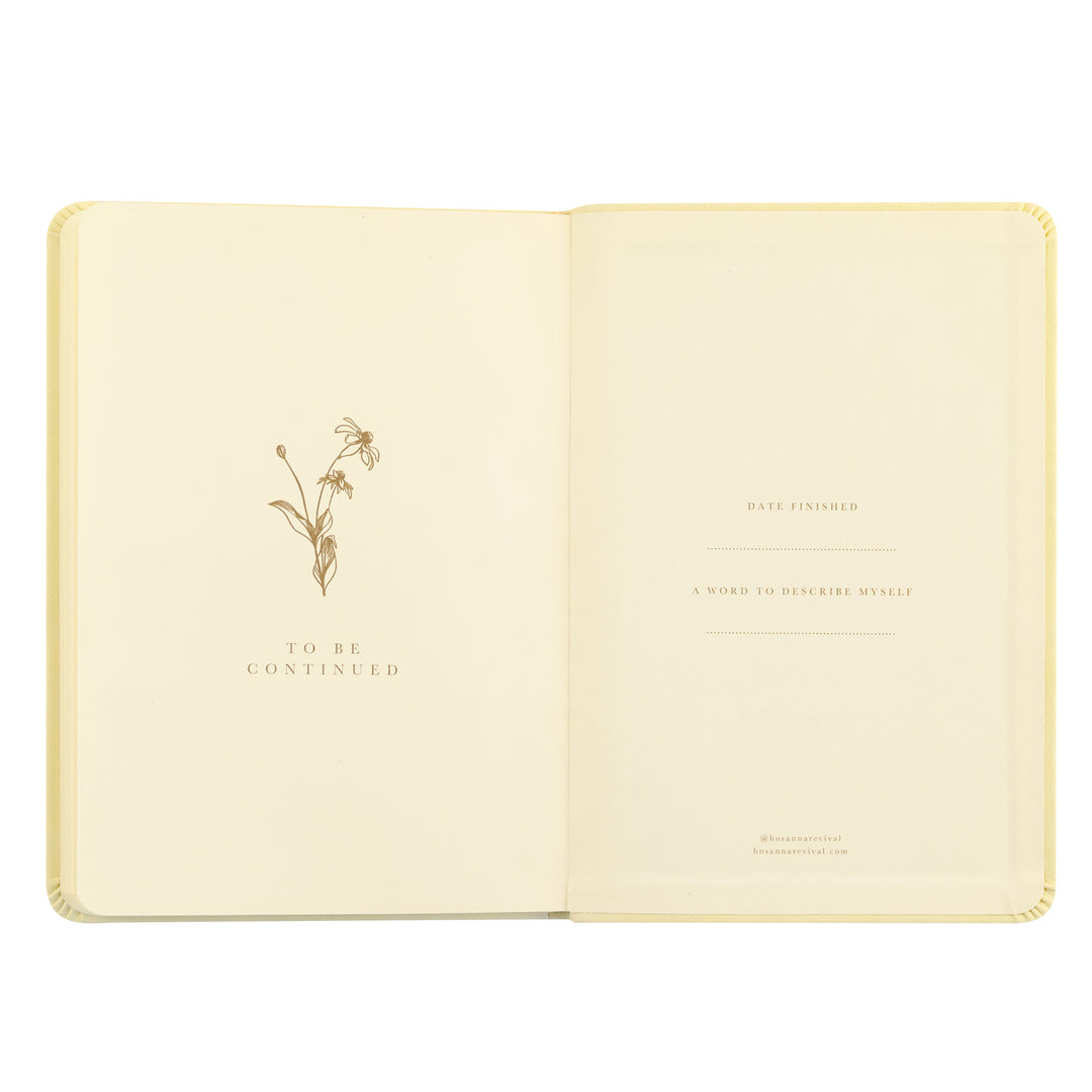 Open book with decorative floral design and text on a white background