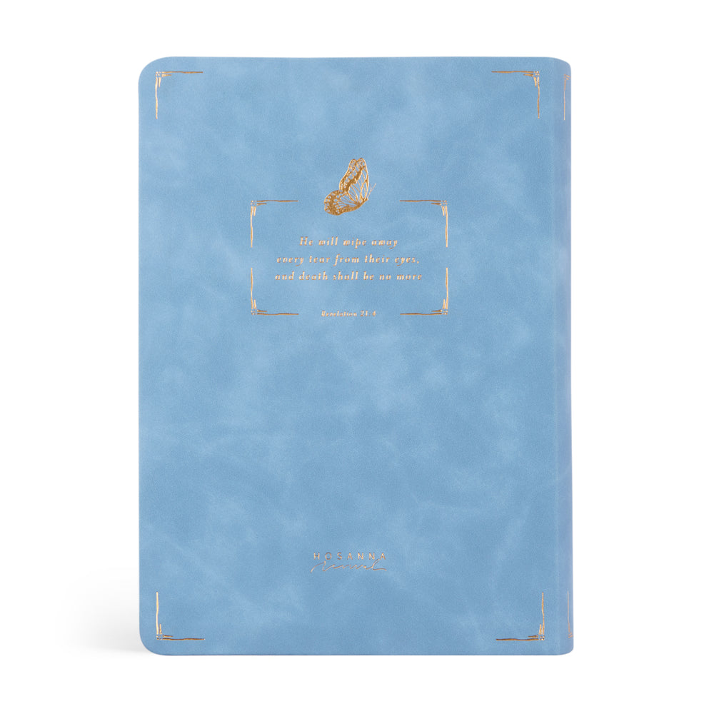 Blue Bible with gold text and design on a white background