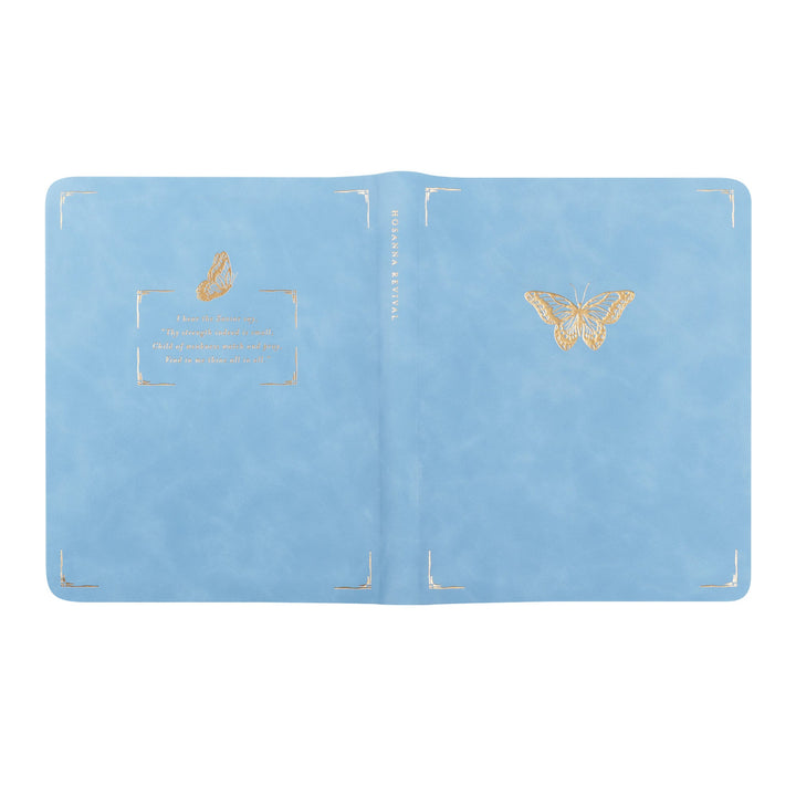 Light blue passport holder with gold butterfly designs on a white background