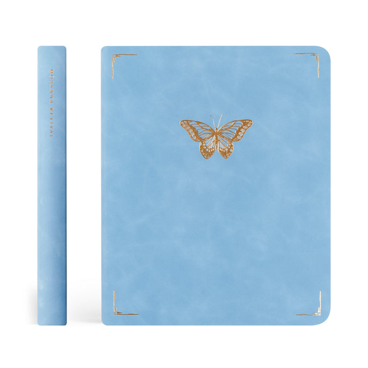Blue notebook with a butterfly design on a white background