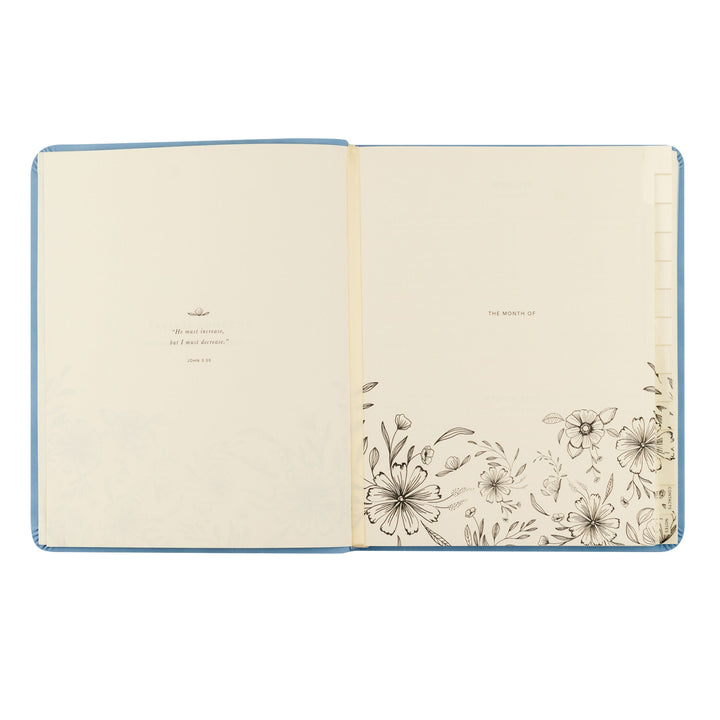 Open notebook with floral design on a white background