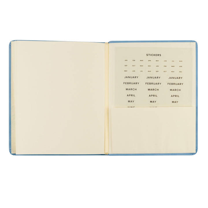 Open notebook with a page of stickers labeled 'January' to 'May'.
