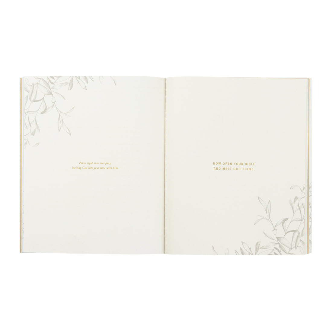 Open book with floral patterns and text on a white background