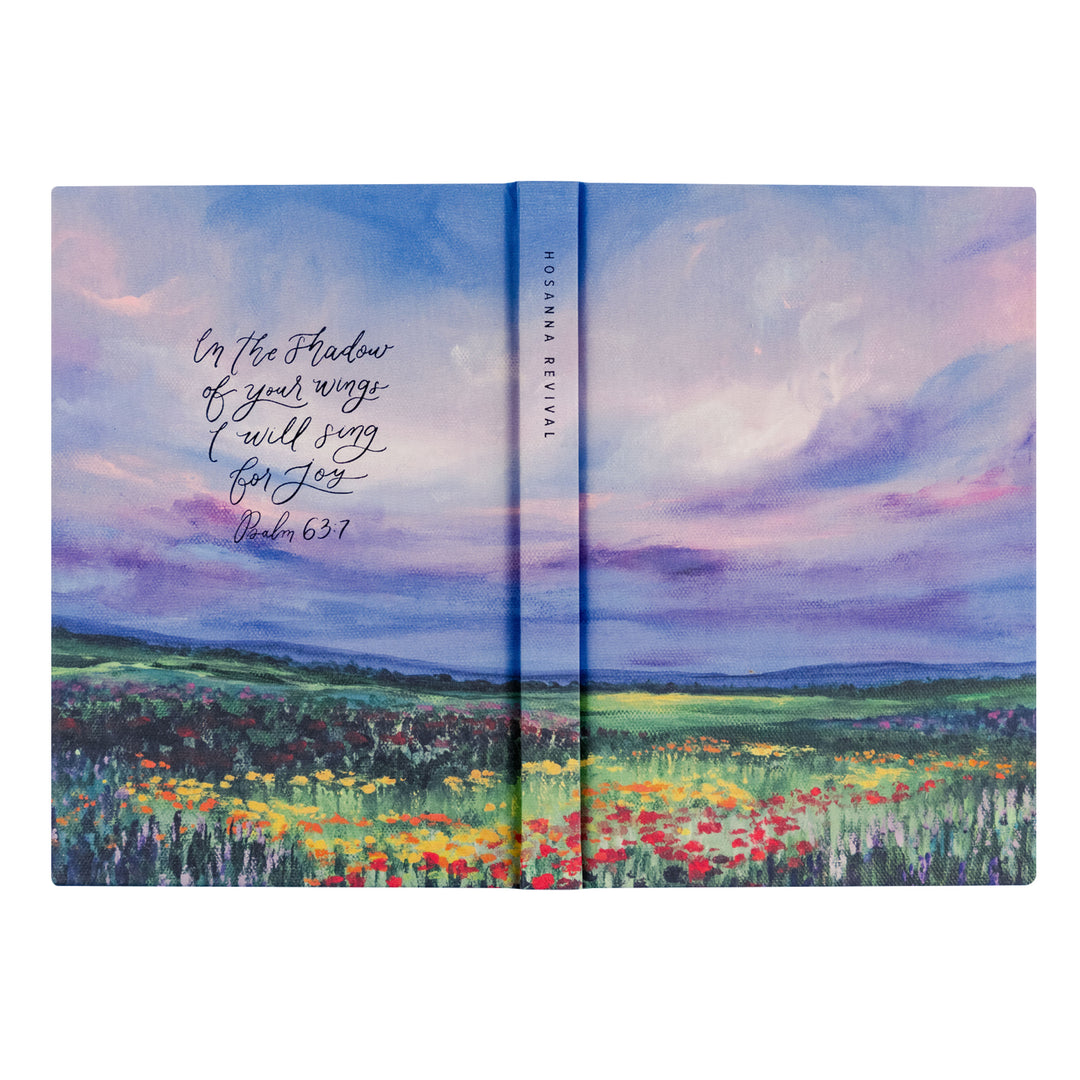 Open notebook with a colorful landscape design and text on a white background