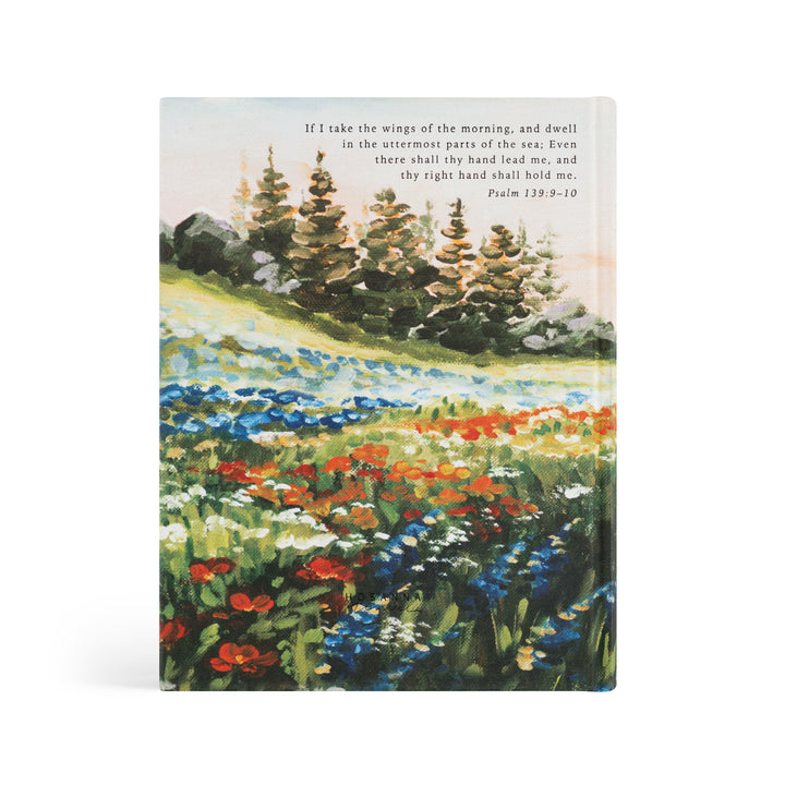 Notebook with a scenic illustration of a field and trees on the cover