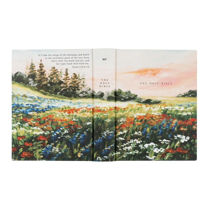 Open book with a colorful landscape illustration on a white background