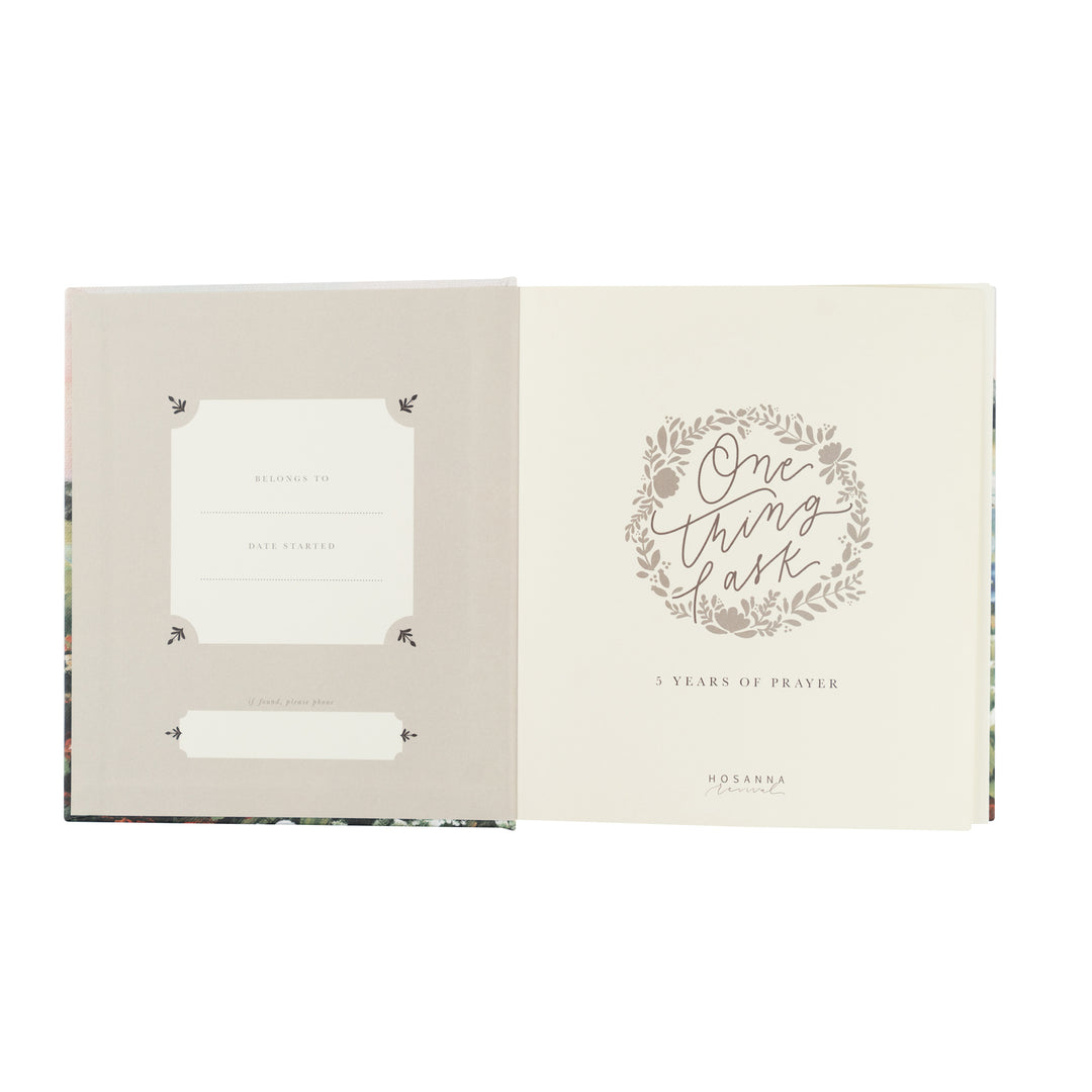 Open book with decorative text and design on a white background