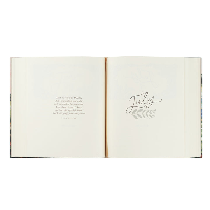 Open book with 'July' written on a white background