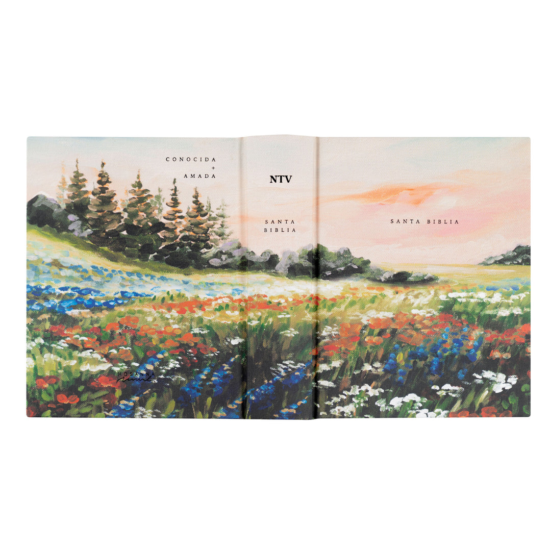 Open book with nature-themed cover showing a field of flowers and trees.