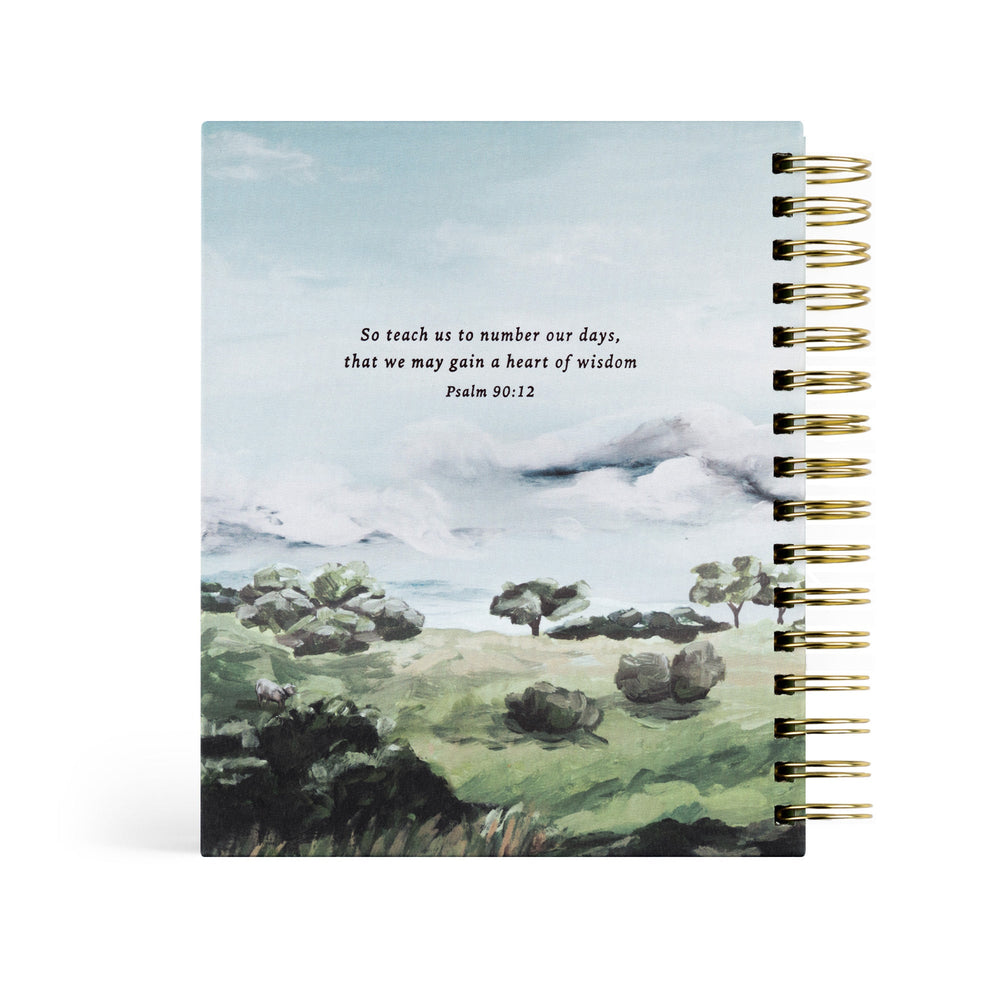 Notebook with landscape illustration and text on a white background