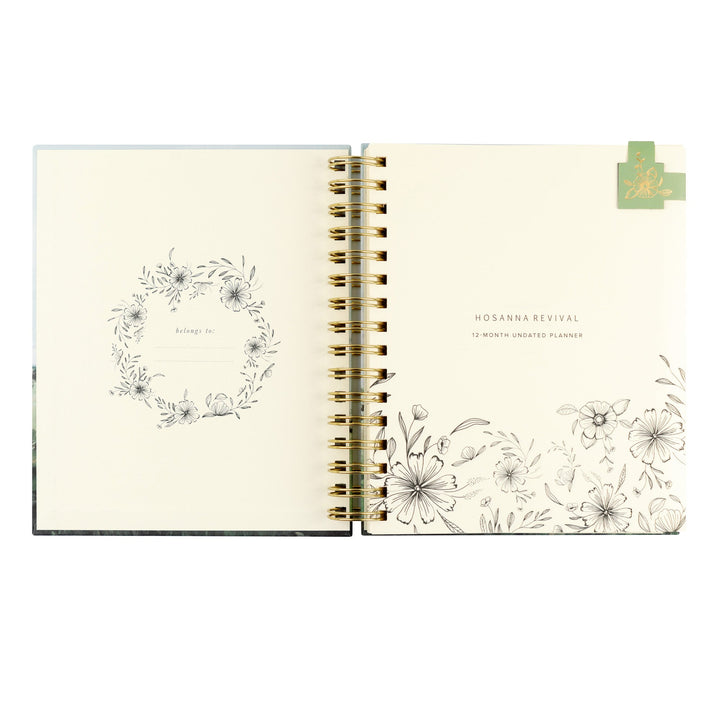Open planner with floral designs on a white background