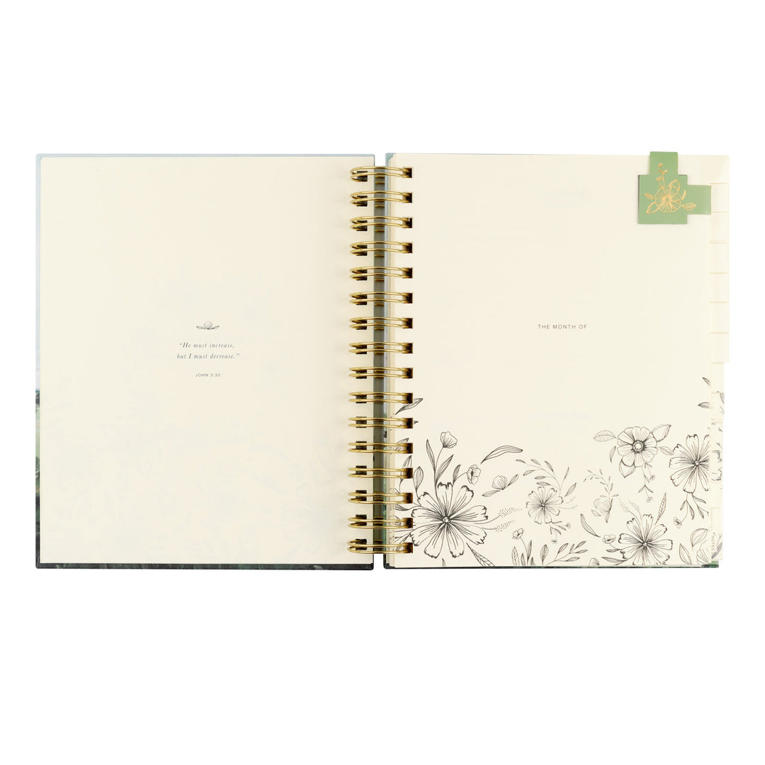 Open notebook with floral design on a white background