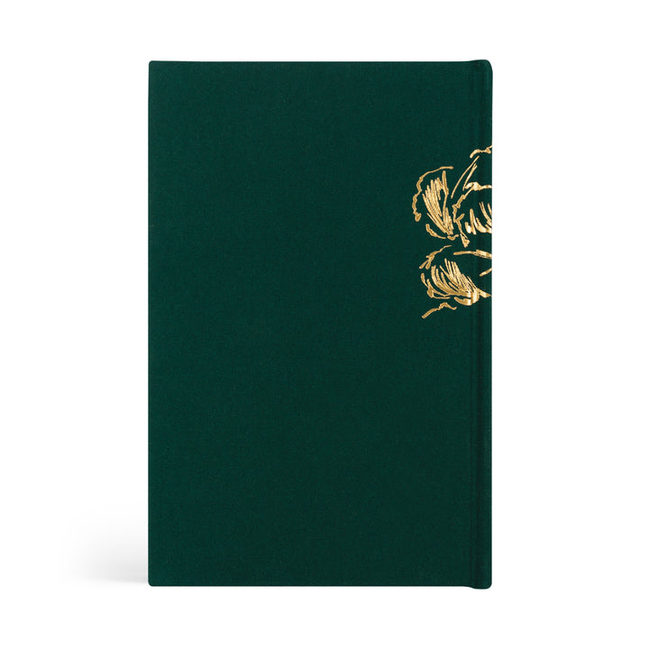Green notebook with gold floral design on a white background