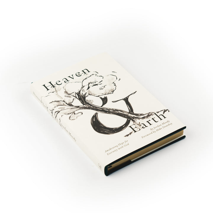 Book titled 'Heaven & Earth' with a floral design on the cover against a white background