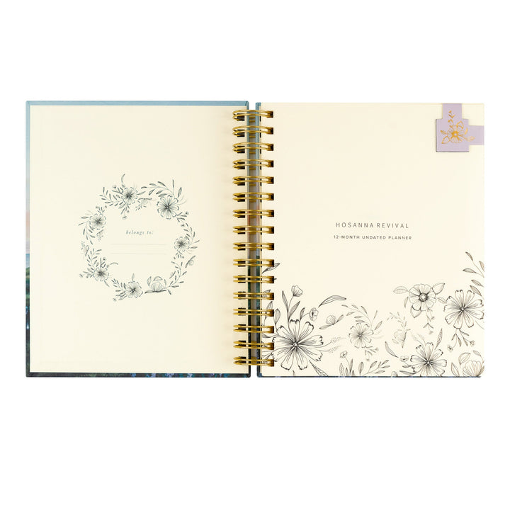 Open planner with floral designs on a white background