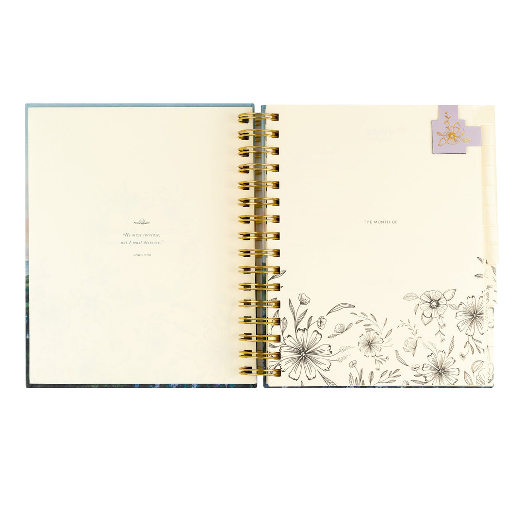Open notebook with floral design on a white background