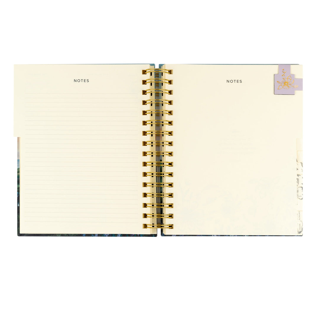 Open notebook with gold spiral binding on a white background