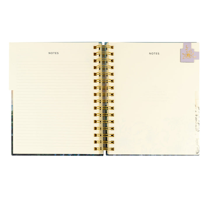 Open notebook with gold spiral binding on a white background