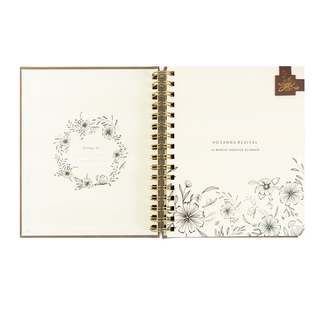 Open planner with floral designs on a white background