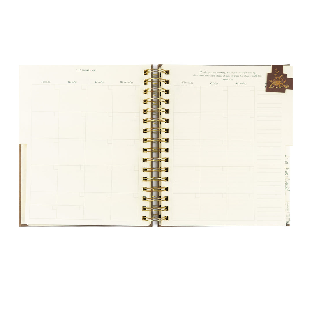 Open notebook with gold spiral binding on a white background