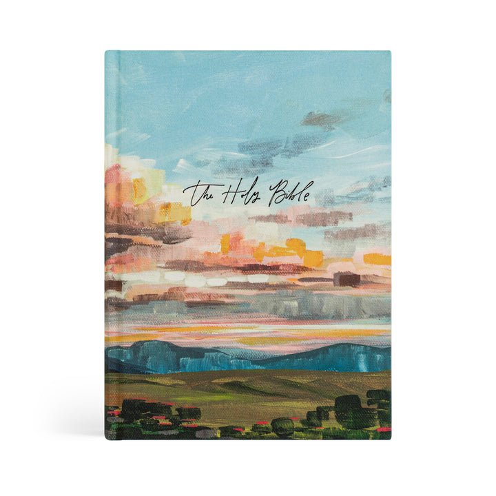 Bible with a colorful landscape design on the cover