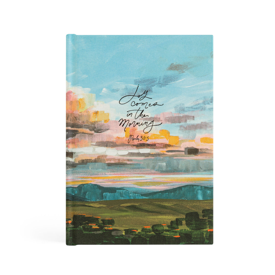 Notebook with a colorful landscape design and text on the cover