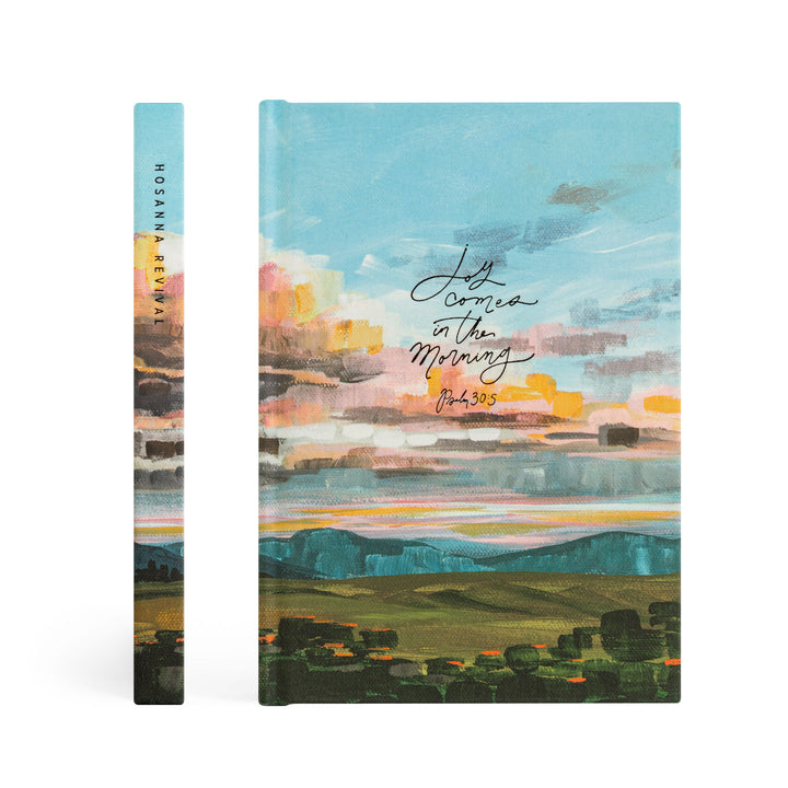 Notebook with artistic landscape cover and text on a white background
