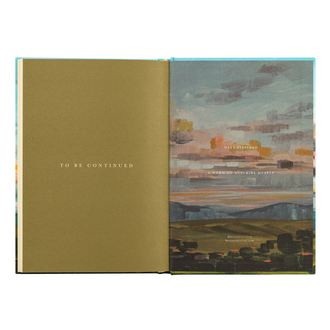 Open book with a green cover and a colorful landscape illustration on the right page.