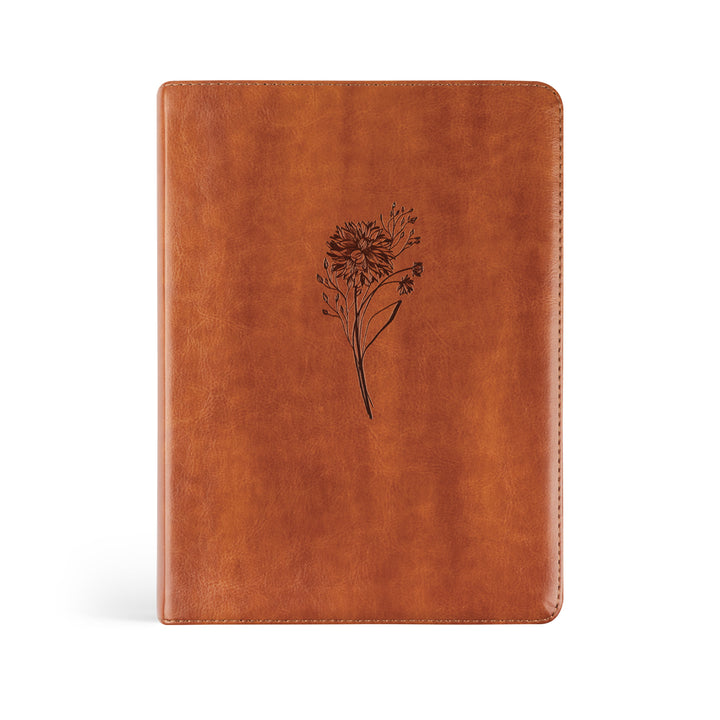 Brown leather notebook with a floral design on a white background