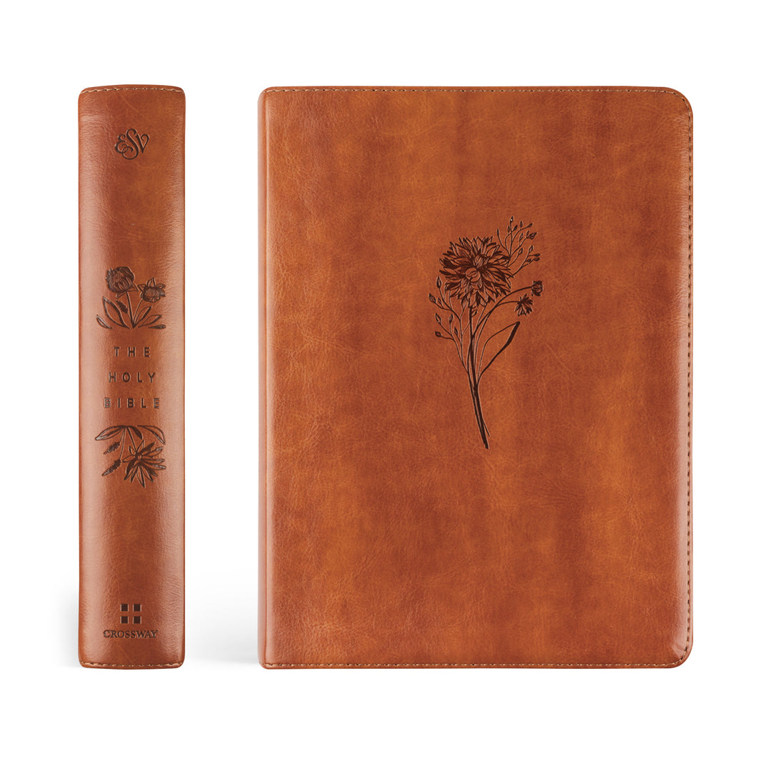 Brown leather-bound book with floral embossing on a white background
