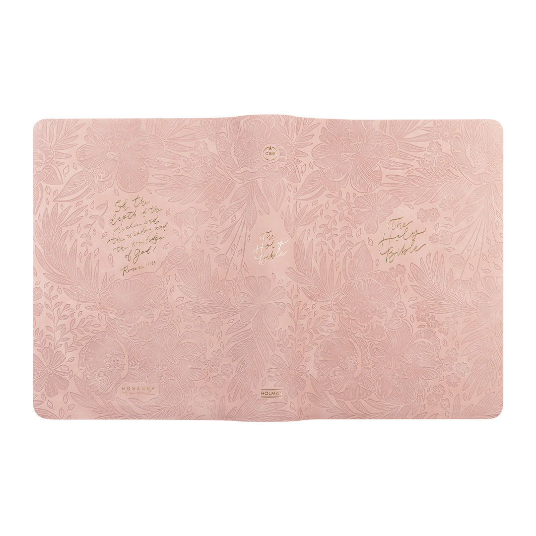 Pink laptop sleeve with embossed design and text on a white background