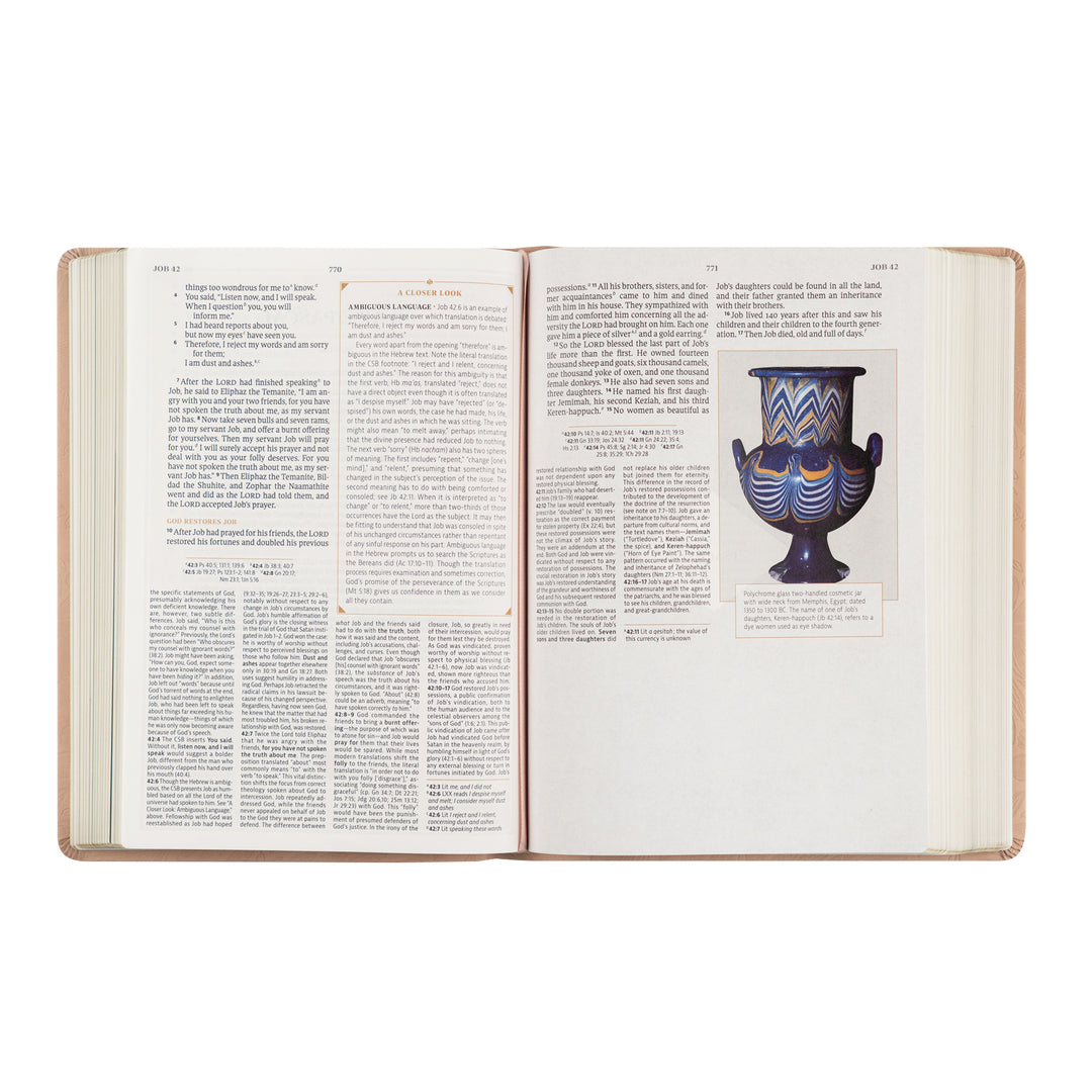 Open book with text and a picture of a vase on a white background