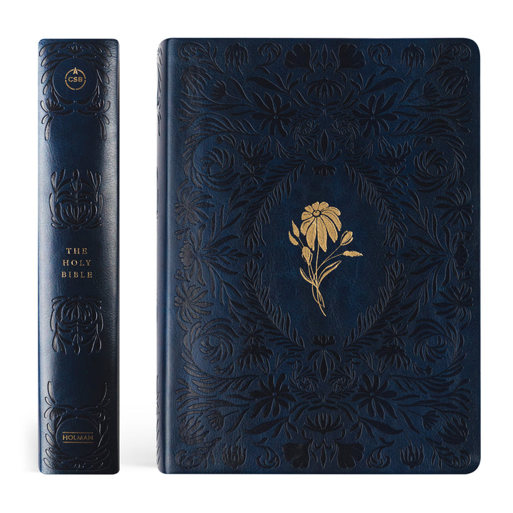 Dark blue embossed Bible with gold floral design on a white background