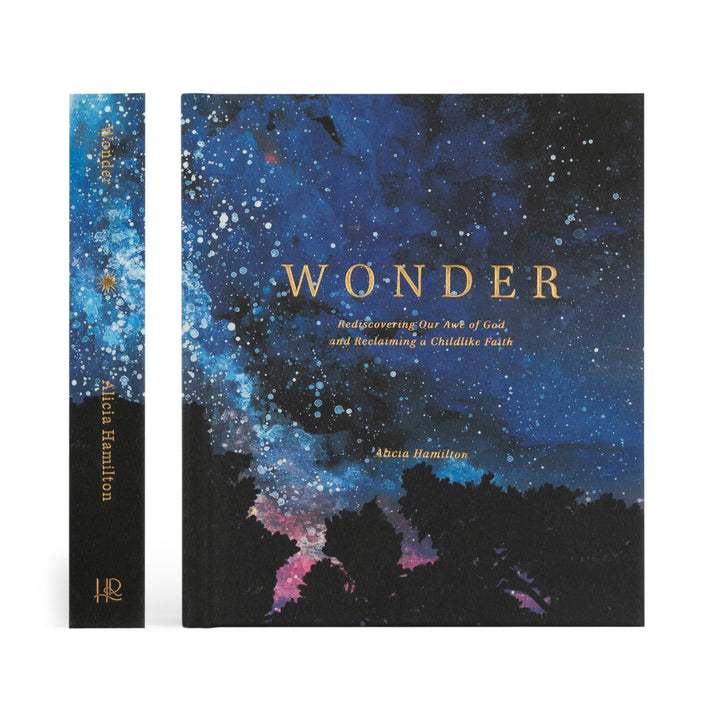 Book titled 'Wonder' with a cosmic design on the cover, showing spine